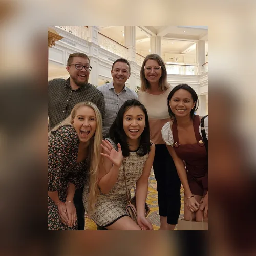 Angelika with five Disney PhotoPass teammates in a resort lobby.